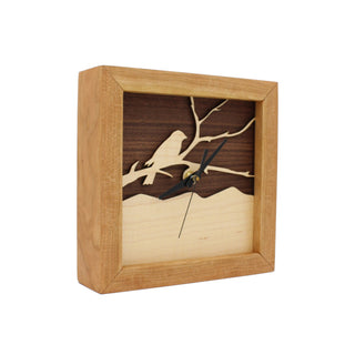 Bird on a Branch - Walnut & Maple, handcrafted Cherry Wooden Box Clock with Bird on a Branch design in maple over a walnut background. Angle view.