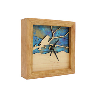 Bird on a Branch - Azure Sky, handcrafted Cherry Wooden Box Clock with Bird on a Branch design in maple over a blue swirled paper background. Angle View.