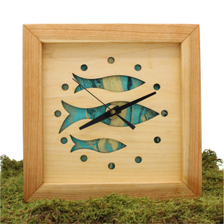 Fish at School, handcrafted cherry wooden Box Clock with fish design in maple over a aqua background. Pictured in moss.