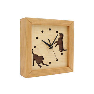 Dogs at Play, handcrafted cherry wooden Box Clock with dog design in maple over a walnut background. Angle view