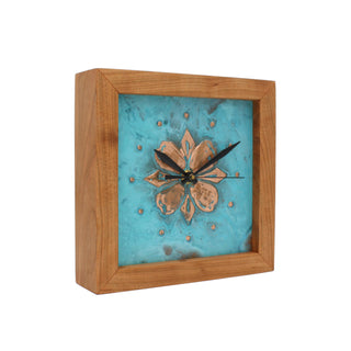 Patina Dogwood, handcrafted cherry wooden Box Clock with patina copper face embossed with a dogwood blossom. Angle view.