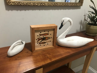 Fish at School, handcrafted cherry wooden Box Clock with fish design in maple over a orange background. Pictured on table with swan decor.