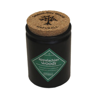 Appalachian Woods scented palm wax candle, made with essential oils in a black jar with a cork lid engraved with Sabbath-Day Woods logo. Top angle view.